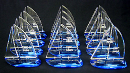 Completed sailboats waiting to be cemented onto black acrylic bases